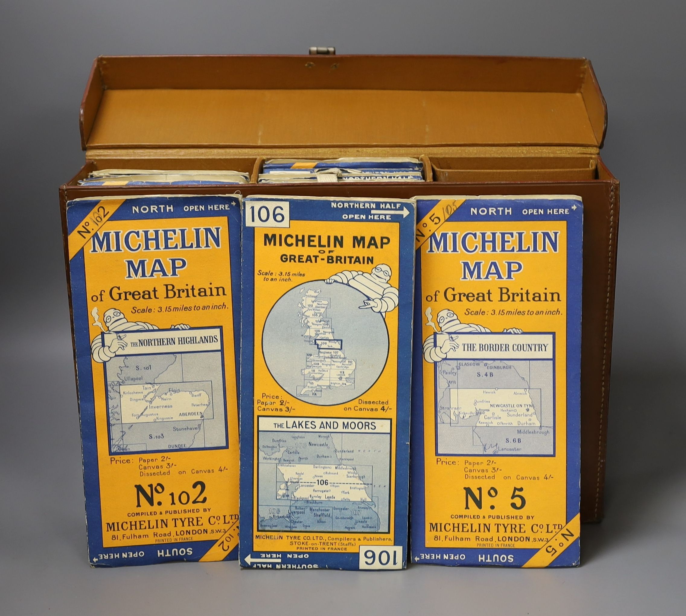 A brown leather map case including Michelin maps of Great Britain